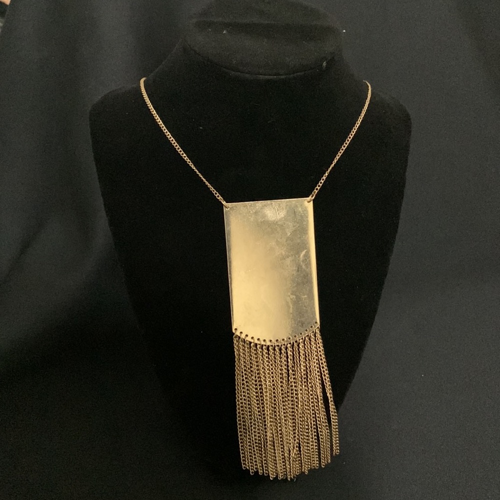 Long gold statement necklace with metallic fringe.